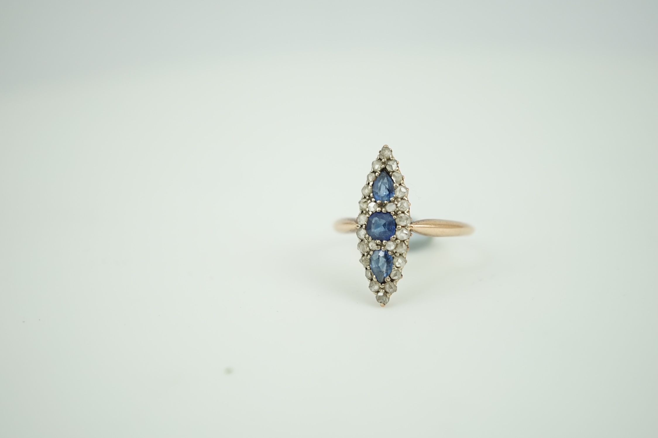 An early 20th century yellow metal, sapphire and rose cut diamond set marquise cluster ring, size Q, gross weight 2.8 grams.